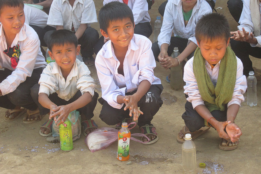 Children learn hand washing techniques at school